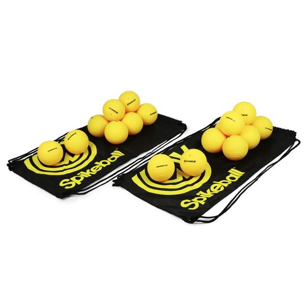 A collection of 20 yellow spikeballs arranged on and off a black carrying bag with the brand name 'Spikeball' visible.