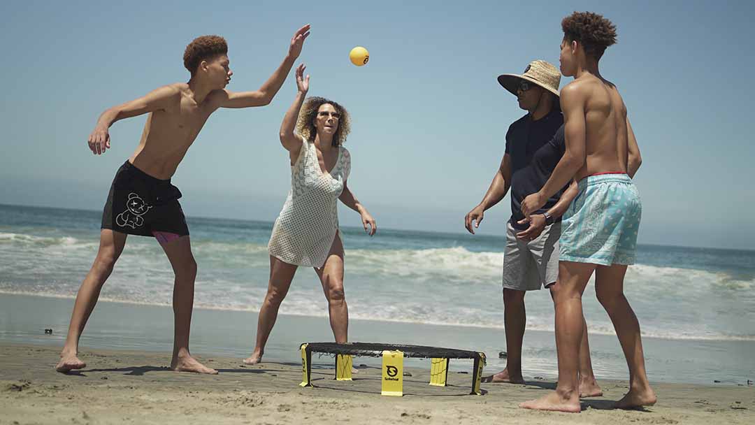 Family having a special time at the beach playing Spikeball