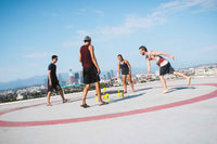 Group of friends playing Spikeball on a rooftop