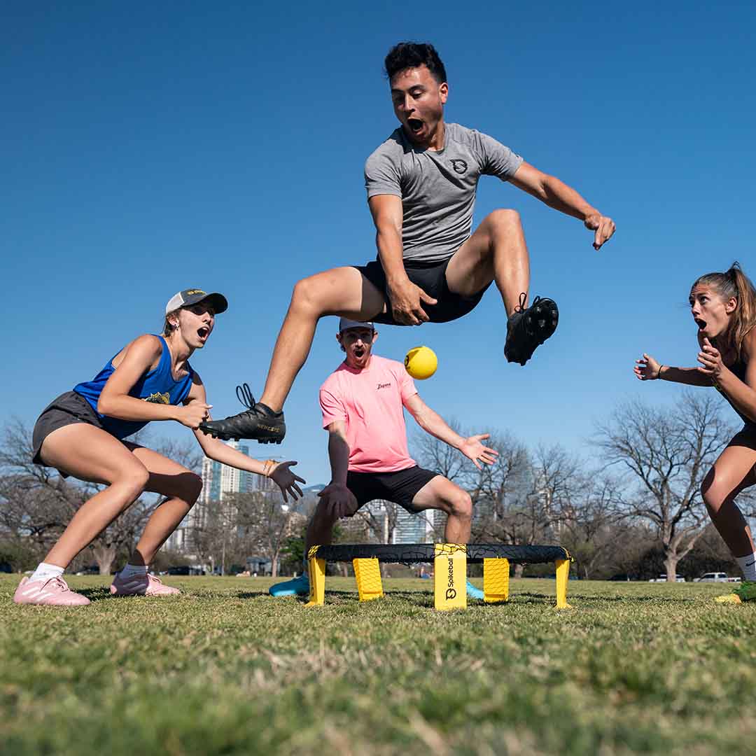 Guy jumping to perform a dramatic Spikeball movement