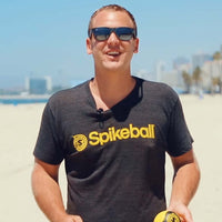 Blond man with sunglasses ready to play Spikeball